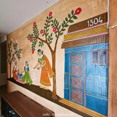 Another angle of the village scene, highlighting the vibrant blue door and the woman drawing a rangoli, showcasing the storytelling aspect of Cheriyal folk painting.