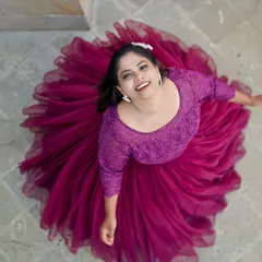 A creative top-down shot of a bride in a flowing purple gown, creating a beautiful circular pattern with her dress.