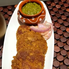 These are my special Yam Kebabs, served with fresh mint chutney and onion rings. They are crispy on the outside and wonderfully soft inside, made with a blend of spices that I've perfected over the years.