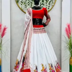 A beautiful white and red georgette chaniya choli. The border of the skirt features printed figures of dancers, adding a playful touch to this Navratri special outfit. It comes with a simple red blouse and a matching white dupatta.