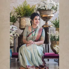 A full view of Ranjitha's stunning ensemble. The saree's drape and the way it catches the light showcases the superior quality of the silk we source.