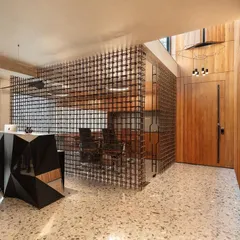 For a construction firm's office in South Delhi, we contrasted raw and refined materials. The reception features a faceted steel desk, terrazzo flooring, and a visually permeable screen made from repurposed rebar, creating a compelling composition that speaks to the client's industry.