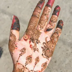 A minimalist design featuring delicate floral and paisley motifs scattered across the hand.