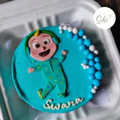 Perfect for a little one's celebration, this Cocomelon bento cake is bright and cheerful. It features a detailed fondant figure of JJ in his pajamas against a vibrant blue background.