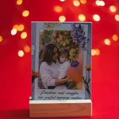 A personalized photo stand with a picture of a mother and child, set against a warm, festive background. A perfect, heartfelt gift for Mother's Day.
