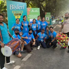 Our full crew, complete with dhol players, at a Bisleri Hydration Station. We are official partners for major events like the Delhi Half Marathon, providing comprehensive on-course support for thousands of participants.