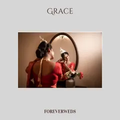 Grace in the mirror. A classic getting-ready shot of the bride, Bhawana, as she puts on her earrings. This perspective adds depth and tells the story of her transformation.