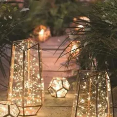 Geometric lanterns filled with twinkling lights create a modern and artistic lighting installation. I placed these along a garden path to guide guests and add a touch of contemporary elegance.