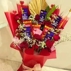 This bouquet is a chocolate lover's dream, featuring an assortment of Cadbury and Nestle bars mixed with real red roses. The gold fan detail adds a touch of elegance to this delicious arrangement.