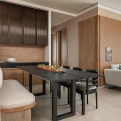 In Apartment 3201, the dining and living areas flow into one another to encourage togetherness. We used a black stained wood dining table and a custom bench to create a modern, blended space that reflects the family's cosmopolitan lifestyle.