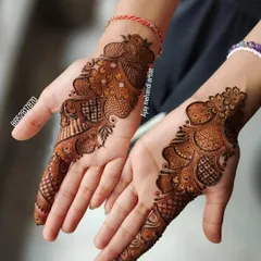 A classic Arabic style mehndi design on the back of the hands. The pattern is focused on one side, creating a stylish and modern look.