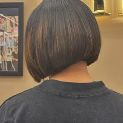 An angled view of a sleek bob haircut, highlighting the subtle graduation and the way it frames the nape of the neck.