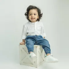 A handsome portrait of the little boy from the twin session, looking so cute in his white shirt and jeans.