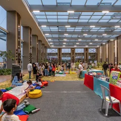 We designed this 40-foot-high glass pavilion to completely blur the line between indoors and outdoors. It allows for community events on a natural lawn while being protected from the elements, fostering a unique connection between people and nature.