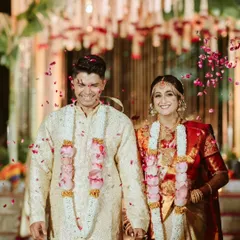 Pure joy and celebration as the couple is showered with petals after their ceremony. Their radiant smiles and the vibrant colors make this a perfect capture of wedding day happiness.