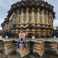 Sitting on the steps of the Vidyashankara temple in Sringeri. The unique star-shaped platform and intricate carvings are a testament to ancient Indian craftsmanship.