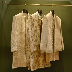 A trio of our ceremonial jackets, showcasing a range of styles from geometric patterns to floral prints and textured weaves. Each piece is designed to offer a distinct personality for any wedding event.