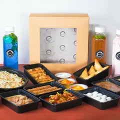 The complete Iftar feast, unboxed and ready to be served. This image showcases the sheer variety and quantity of food you receive, from multiple main courses and biryani to a selection of starters, desserts, and colorful beverages.