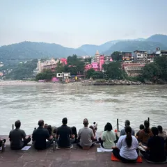 Our sangha meditates together on the banks of the holy Ganges during a yoga retreat in Rishikesh. Practicing in nature amplifies the sense of peace and connection to the universal spirit.