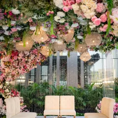 The view from the mandap, looking out from under the canopy of the upside down garden. The hanging crystal chandeliers add a touch of glamour, catching the light and sparkling amidst the flowers.