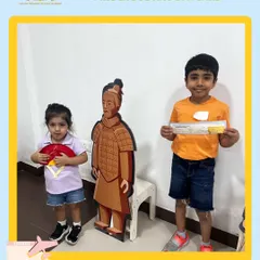 Posing with a Terracotta Warrior cutout and a traditional fan, our campers get their first taste of Chinese culture. These thematic photo opportunities make the experience more immersive and memorable.