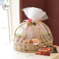 A beautifully wrapped Rakhi gift basket. This hamper is filled with jars of my best-selling treats and comes with complimentary Rakhis, all bundled in a rustic basket with delicate tulle and floral accents.