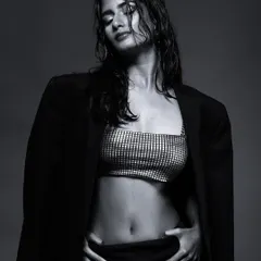 Another shot from the "wet look" series, this time with the model's eyes closed, conveying a sense of calm intensity. The monochrome edit emphasizes the textures of the wet hair and clothing.
