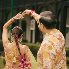 A beautiful shot from the back, showing off the intricate parandi braid and the colorful details of her lehenga.