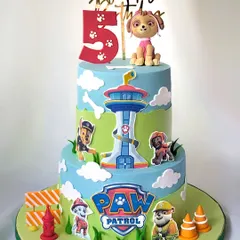 A big, bright, and fun Paw Patrol cake for a 5th birthday. This two-tier creation features the lookout tower, the Paw Patrol logo, and all the favorite characters, with a special focus on Skye.