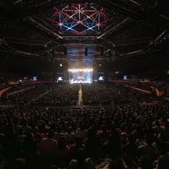 A wide-angle view of the 14,000-person crowd at the indoor stadium in Delhi. The sheer scale of this sold-out show was a massive victory for Indian classical music.