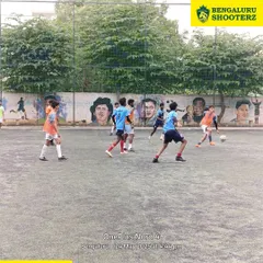 A wide view of a practice match in progress, with our players spread across the turf, learning to maintain their positions and anticipate the play.