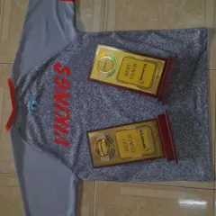 Excellence in coaching is the foundation of our success. Here are two "Best Coach" awards displayed proudly on a Vikings jersey, proving that our leadership is among the best.