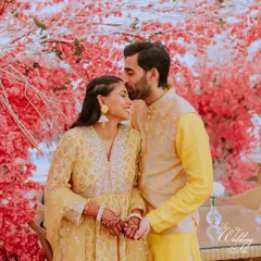 A beautiful portrait against a stunning cherry blossom backdrop, the groom's tender forehead kiss says it all.