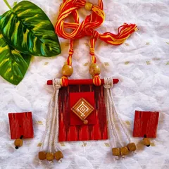 An Ikat-inspired fabric necklace with wooden beads and jute tassels. This piece has a rustic, earthy feel and is perfect for lovers of handloom and natural textures.
