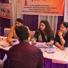 Providing one-on-one legal counseling at the DLSA legal aid stall at Sheetla Mata Mandir. Many people hesitate to approach a lawyer, and these camps create a friendly, accessible environment for them to seek help.