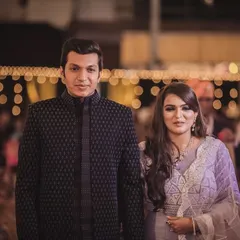 A classic black open Indo-Western jacket, elevated with subtle moti and katdana work. This outfit is designed for formal evening events where elegance is key.