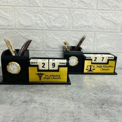 I craft these professional desk organizers that combine a lifetime calendar, a clock, and a pen stand. Here you can see two examples customized for a doctor and a judge, showing how I can tailor them with specific names and professional symbols.