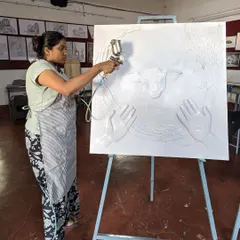 Here, I am applying a base coat with a spray gun to my 'The Lost Sheep' mural. This step is crucial for ensuring an even finish and preparing the textured surface for detailed painting.