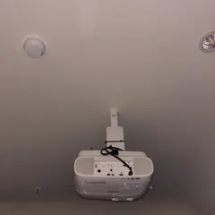 A view of the ceiling-mounted projector, showing the clean wiring and secure bracket. We handle all aspects of the installation to ensure a safe and professional finish.