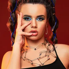 An edgy and creative portrait using safety pins as accessories. This look combines bold makeup with unconventional styling to create a memorable, high-fashion statement.