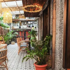 Every corner of the cafe is thoughtfully designed to offer a sense of peace. This is a view of our tranquil outdoor space, ready for you to settle in.