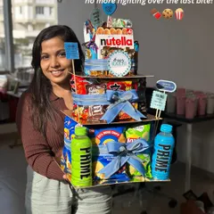 Here I am with our epic Rakhi Food Tower Hamper! I designed this so there’s no more fighting over the last bite. It’s stacked high with all the snacks and chocolates that celebrate the sweet and salty nok-jhok of the sibling bond.