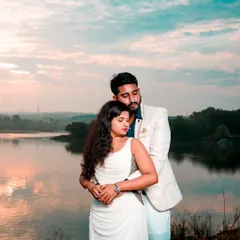 A romantic embrace by the lake at sunset. The beautiful natural light and serene setting make this a perfect photo for a "Save the Date."
