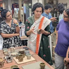 During our Open Studio events, I conduct reviews of student artwork. Here, I'm discussing the glaze results on a finished piece, sharing insights on how the fire and glaze interacted to create the final effect.
