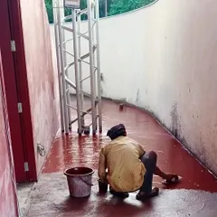 An artisan meticulously applies traditional red oxide flooring at the TAPMI Centre. This process is a personal exploration for us, reviving ancestral skills within a modern architectural narrative.