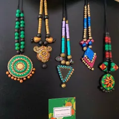 A beautiful array of my terracotta creations. These pieces, with their vibrant colors and diverse designs, are perfect for adding a touch of handmade charm to any outfit.