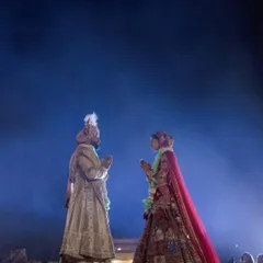 The varmala exchange is the first step in the union. I stage this moment on an elevated platform with dramatic backlighting to create a divine, larger-than-life silhouette, symbolizing the significance of this sacred ritual.