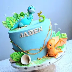 A fun dinosaur cake for a fifth birthday. This design features two cute, hand-sculpted fondant dinosaurs, edible soil, and tropical leaves, all of which I show you how to make in my classes.