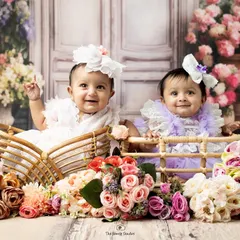 We captured the pure joy of these twin sisters interacting during their studio photoshoot. Our team is experienced in working with multiples to create beautiful, coordinated portraits.