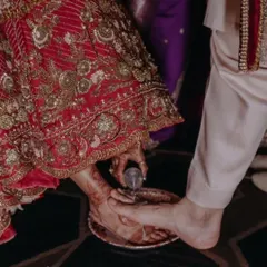 A beautiful moment from a wedding ritual, where the bride's mehendi-adorned feet are part of the ceremony. It's a reminder of how mehendi is woven into our traditions.